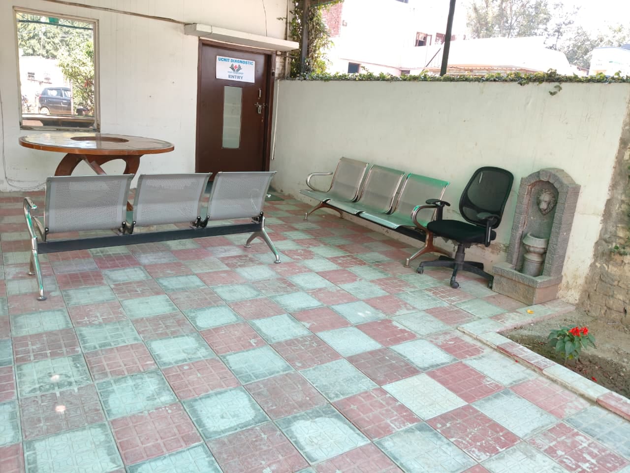Covered outdoor seating area beside the entrance of Uchit Diagnostic