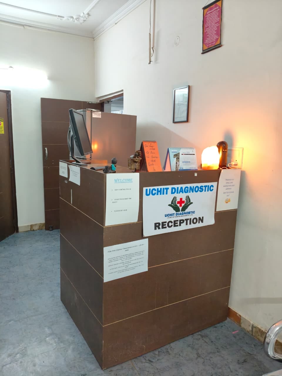 Reception counter with the Uchit Diagnostic sign at the centre